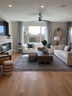 a living room filled with furniture and a flat screen tv mounted to the wall over a fireplace