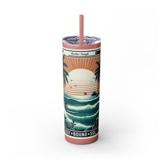 a pink tumbler cup with an image of the ocean and palm trees on it