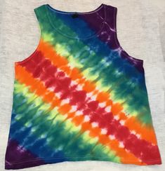 Medium Anvil lightweight unisex 100% cotton tank top tie dyed in a diagonal accordion fold & striped in a mirrored rainbow motif. All of our tie dyed & bleach discharged items are made individually to be one-of-a-kind pieces. We can try to replicate patterns with any other colors, but cannot guarantee the same effects. Tie dyes are unique, so what you see here is what you get - not something similar to this one, but THIS ONE. Accordion Fold, Diagonal Stripes, Cotton Tank Top, Tie Dyed, Gender Neutral, Tie Dye, Adult Outfits, Tank Top, Rainbow