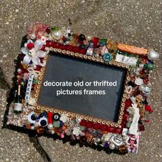 there is an old photo frame that has been decorated with glass beads and other items