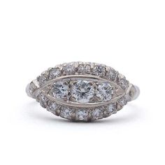 a three stone ring with diamonds on the sides and two rows of round stones in the middle