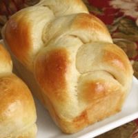 three rolls sitting on top of a white plate