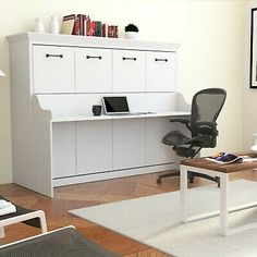 an office with white furniture and wooden floors