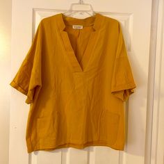 Anna Kaci Gold Top. Cotton Blend. Xl V Neck. Front Pockets. Perfect Fall Color. Wear Over T Top Or Long Sleeve Shirt. New Condition; Never Worn Oversized V-neck Top For Summer, Oversized Yellow Tops For The Beach, Vertical Striped Blouse, One Shoulder Ruffle Top, Denim Blouse, Top Pants Set, Gold Top, Anthropologie Top, Fall Color