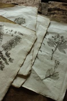 four napkins with flowers and leaves on them