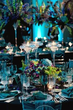 the table is set with many glasses and place settings for dinner guests to enjoy their meal