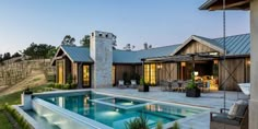 a house with a swimming pool in the middle of it and an outdoor dining area next to it