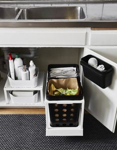 the kitchen sink is full of cleaning supplies