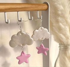 two pink and white stars hanging from hooks