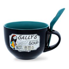 a black coffee cup with a spoon in it and an advertisement for salty's soup on the side