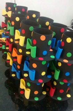 several black vases with colorful polka dots on them