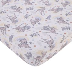 a baby bed sheet with cartoon animals on it