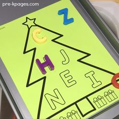 a close up of a sheet of paper with letters and numbers in the shape of a christmas tree