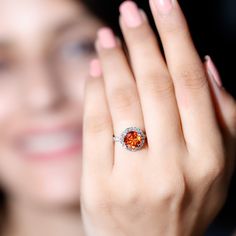 a close up of a person holding a ring