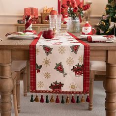 the table is set for christmas with red and green decorations