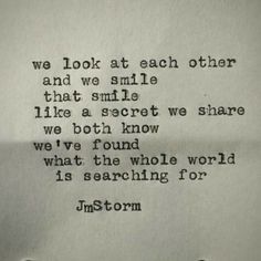 an old typewriter with the words we look at each other and we smile that smile like a secret we know we've found what the whole world is searching for