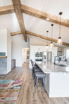 a large kitchen with an island in the middle and lots of counter space on one side