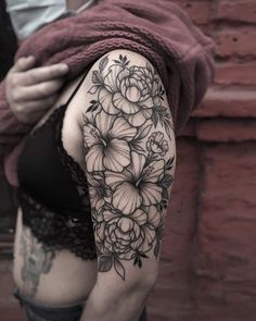 a woman's arm with flowers on it, and a black and white tattoo