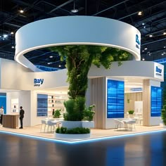 an exhibition stand with plants and people standing around the exhibit area in front of it