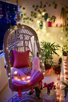 a wicker chair sitting on top of a patio covered in plants