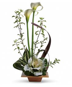 an arrangement of white flowers in a wooden vase