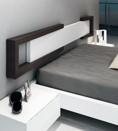 a modern bed with white and brown headboard, night stand and nightstands on either side