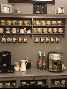 a coffee bar with mugs on the shelves