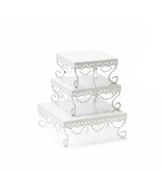 three tiered white cake stand with decorative designs