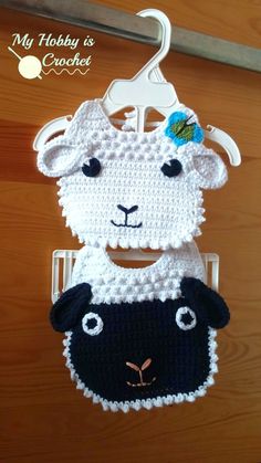 two crocheted sheep hanging from a hook