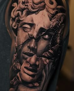 a man's half sleeve with an image of a woman and snake on it