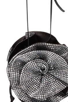 The Magda bag is Magda Butrym's iconic handbag: a bucket bag adorned with large 3D roses on either side of the body, and a leather crossbody strap. The crystal version adds a signature element of Magda DNA through its sparkling, crystal-covered flowers. Exterior: 80% Satin (72% Viscose 28% Silk) 10% Calf Leather 10% Nappa Lamb. Flower 100% Silk. Crystals. All handbags and accessories are considered final sale and may not be returned or exchanged. Luxury Evening Bag With Round Handle For Party, Evening Bucket Bag With Rhinestones, Evening Bucket Bags With Rhinestones, Glamorous Evening Bucket Bag, Party Bucket Bag With Top Handle, Designer Top Handle Bucket Bag For Evening, Designer Bucket Bag With Top Handle For Evening, Luxury Bucket Bag With Top Carry Handle For Party, Designer Shoulder Bag With Round Handle For Party