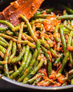 cooked green beans with sauce in a pan