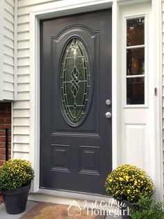 the front door is painted black and has yellow flowers