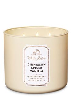 a white candle with cinnamon spiced vanilla inside