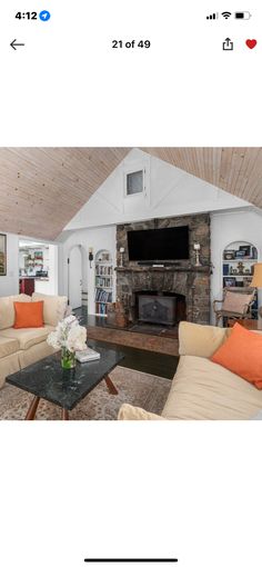 a living room with two couches and a fireplace in the center is featured on an instagram