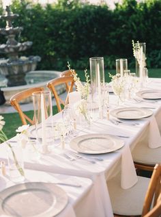 the table is set with plates and glasses