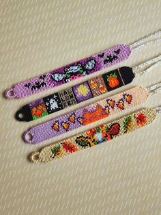 three different colored beaded bracelets sitting next to each other on top of a table