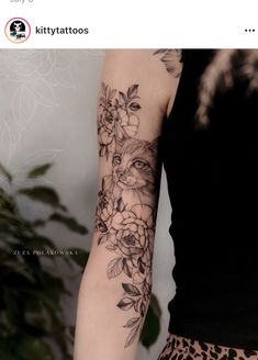 a woman's arm with flowers and a cat on it