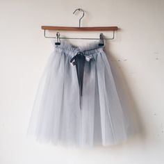 This beautiful handmade tulle skirt is a dressing up box essential that budding fairies will love and not want to take off! It is perfect for birthday parties, weddings, festivals, imaginative play or everyday. This TULLE SKIRT features ... * 3 full layers of soft fine tulle * 100% nylon * elasticated gathered waist  * grosgrain ribbon fastening This beautiful floaty skirt sits at mid calf and has an elasticated paper bag (gathered) waist that ties with a grosgrain ribbon.  This skirt is open at Grey Tulle Skirt, Romantic Tutu, Shimmer Leggings, Sequin Cape, White Tulle Skirt, Fairy Outfit, Heirloom Dresses, Fancy Dress Up, Footless Tights