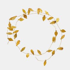 a gold necklace with leaves on it