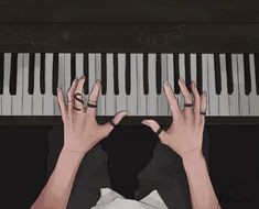 two hands are playing the piano with their fingers on top of each other's head