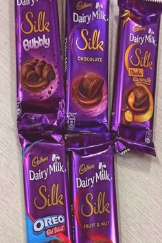 six dairy milk silk chocolate bars stacked on top of each other, with one bar in the middle