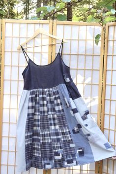 a blue and white dress hanging on a wall