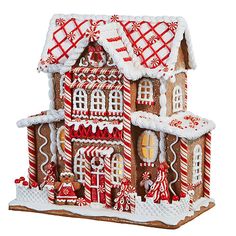 a gingerbread house is decorated with candy canes