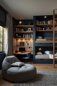 a bedroom with blue walls and shelves filled with books, furniture, and a round ottoman