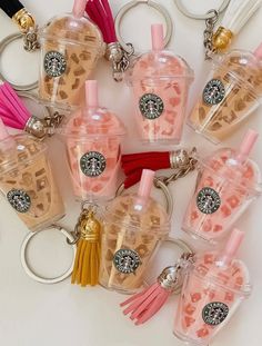 the starbucks keychains are made out of plastic cups with tassels on them