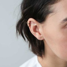 a close up of a person wearing an earring