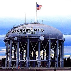 the sacramento city of trees water tower with an american flag on top