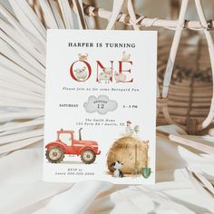 a one year birthday card with farm animals on it and a tractor in the background