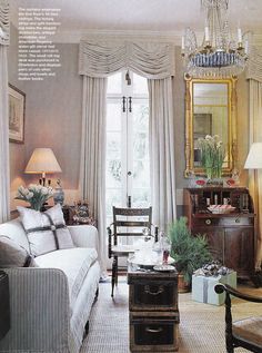 a living room filled with furniture and a chandelier